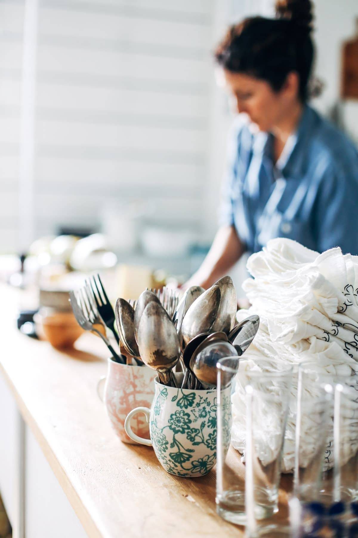 Mugs with utensils.