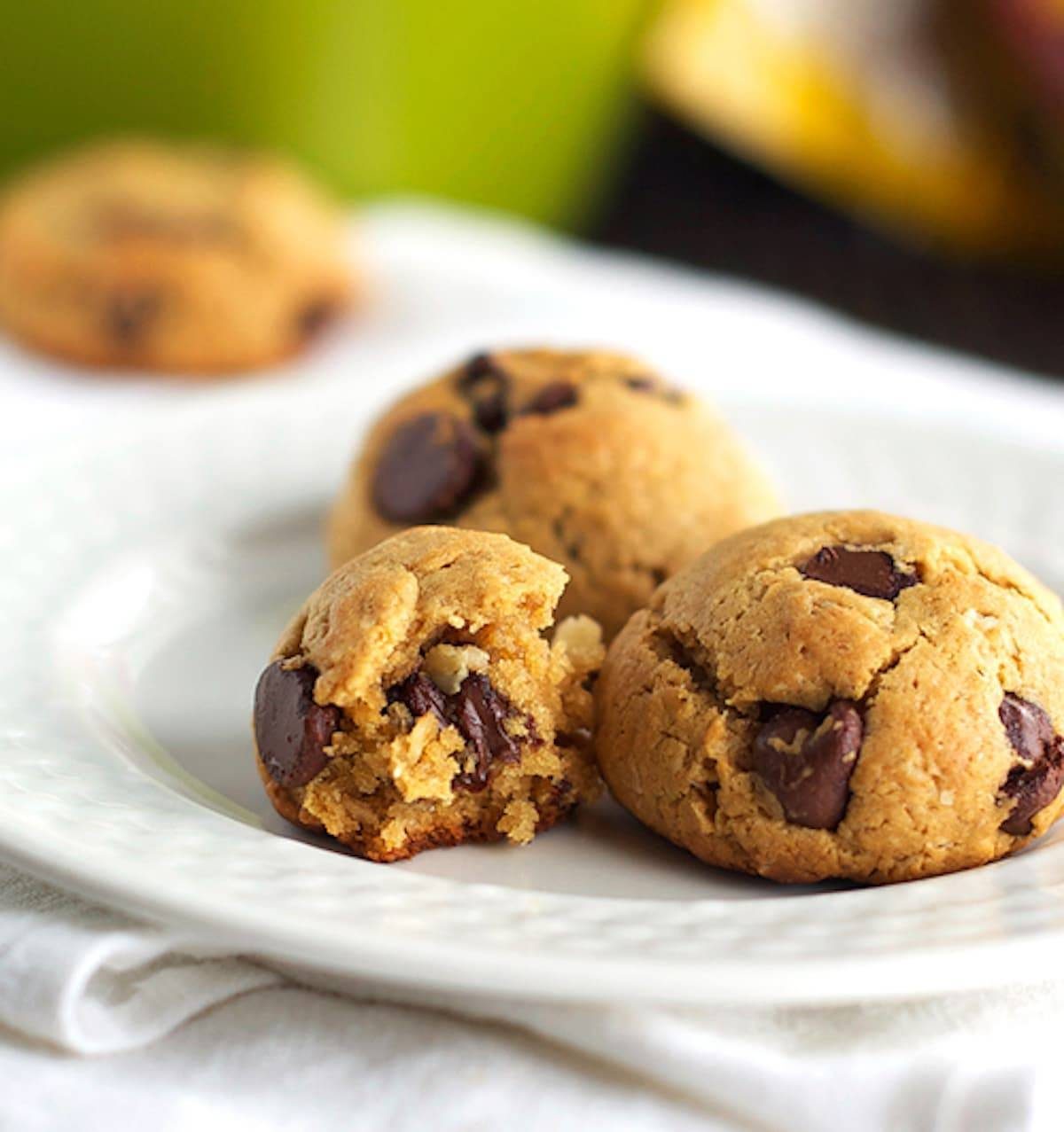 Chocolate chip peanut butter healthy cookie dough in balls on a plate.